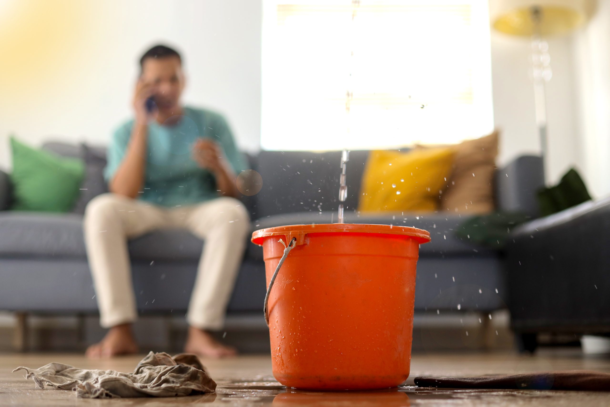 A stressed man dealing with a roof leak