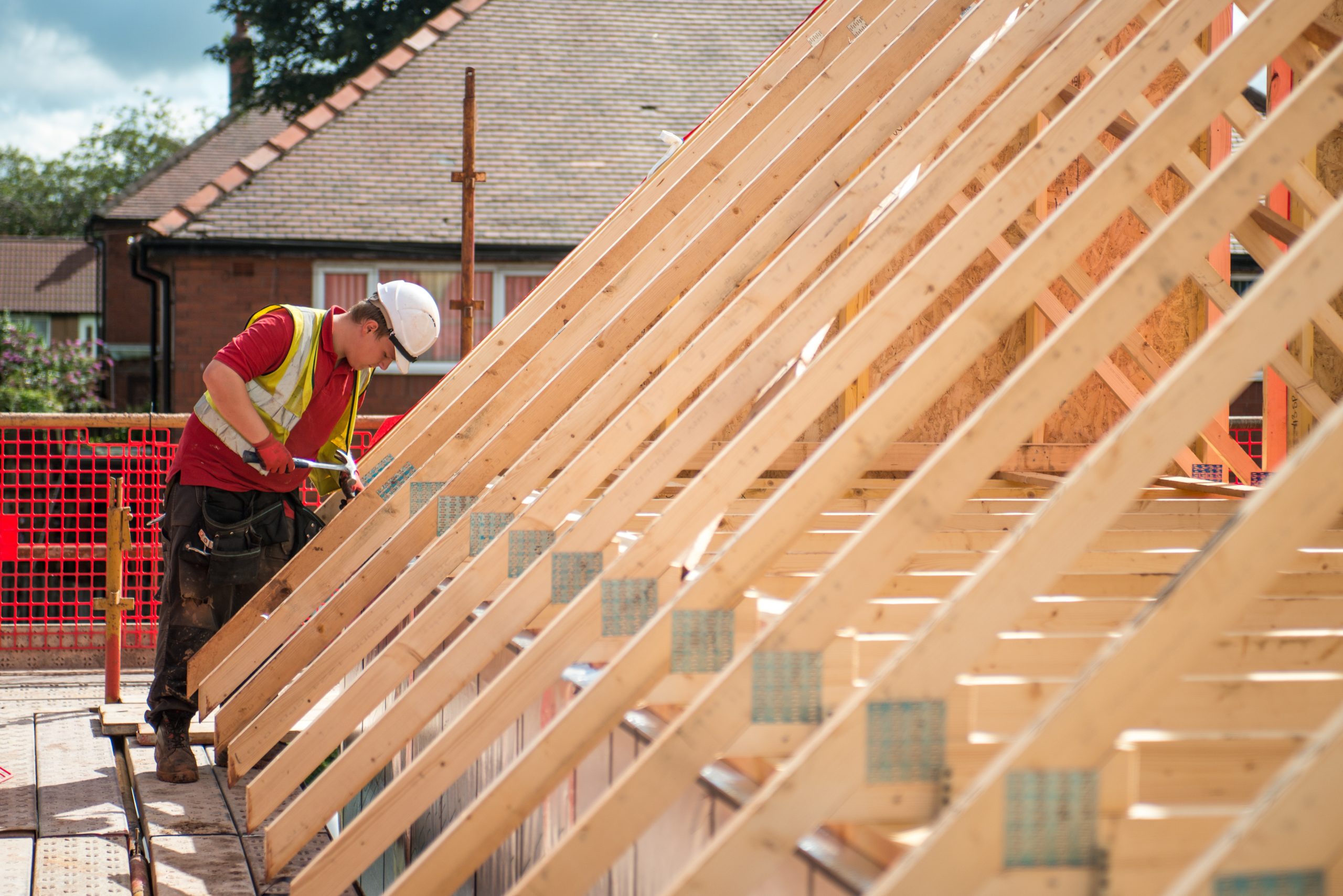 Worker constructing new roof trusts